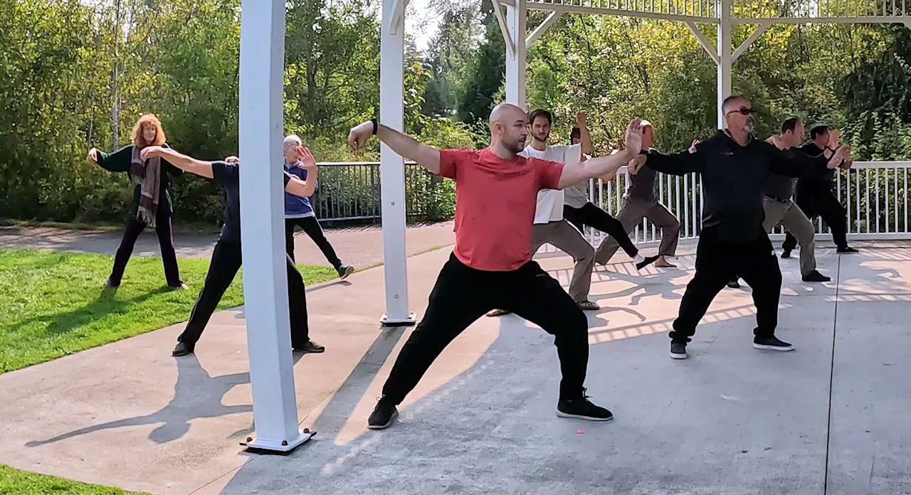 Tai Chi practitioners performing the Single Whip posture at the 2022 Mid-Autumn Tai Chi Festival